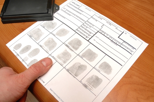 alleged criminal being fingerprinted